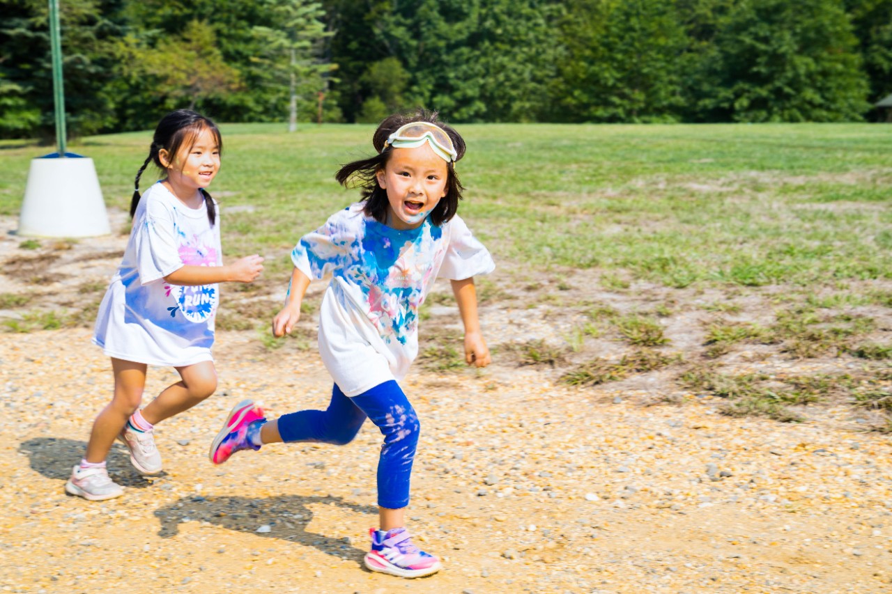 Two Girl Scouts Running at a Color Run 