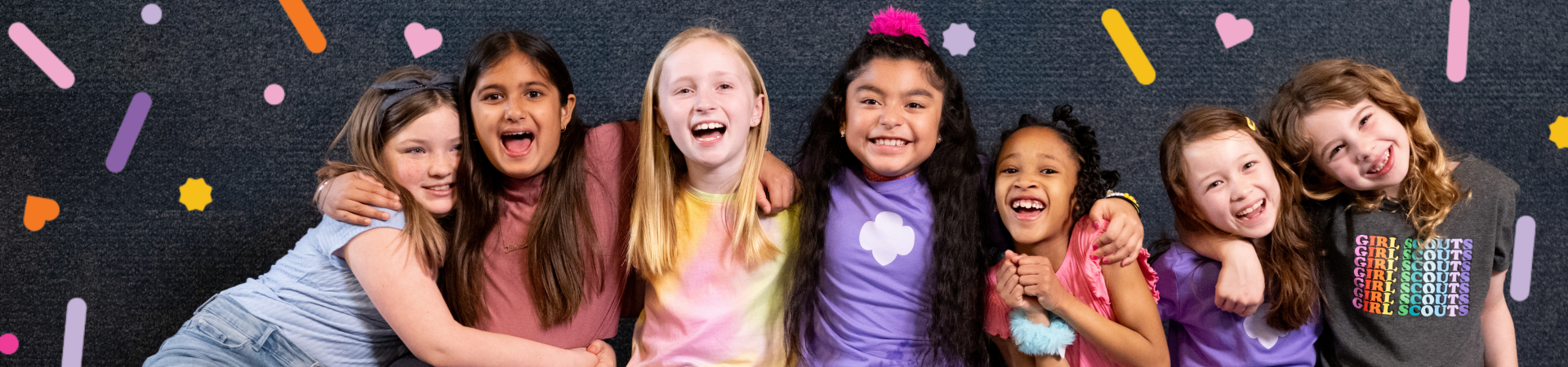  Group of Girl Scouts smiling at each other outdoors 
