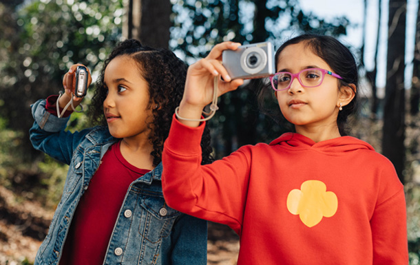 girl scouts looking through cameras