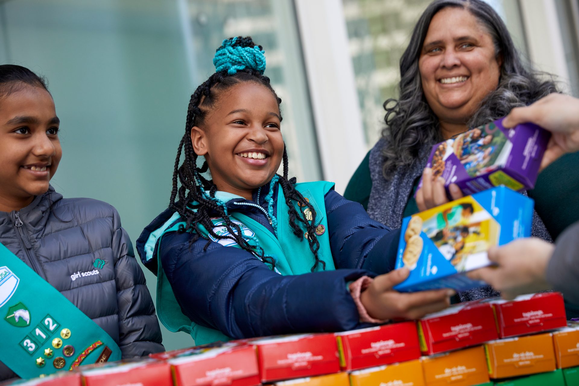 Image: A Girl Scout selling cookies.