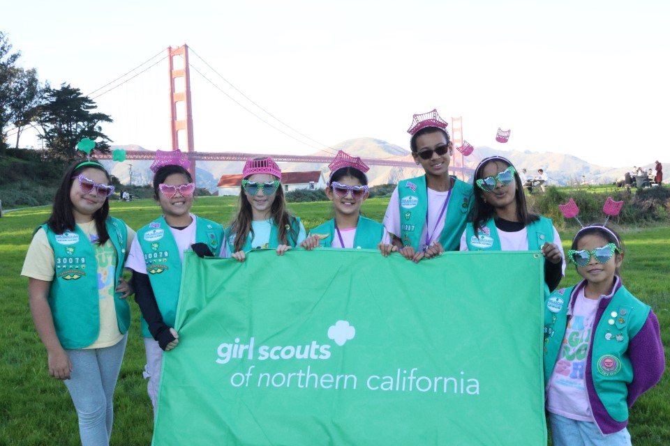 Girl Scouts Holding Flag in front of the Golden Gate Bridge